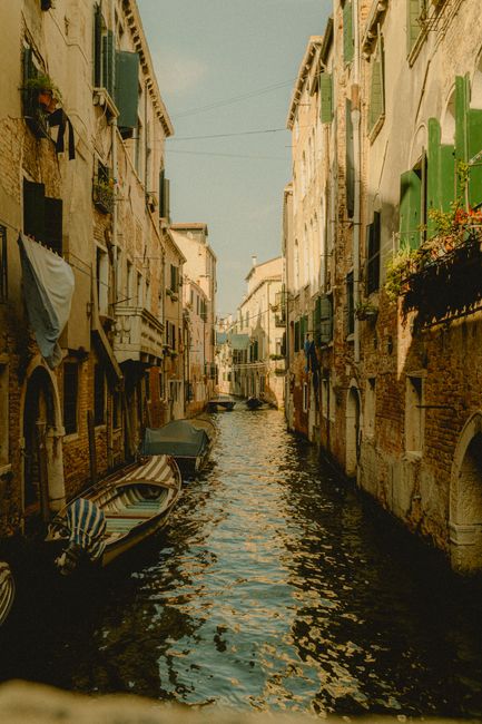 Explore a picturesque canal in Venice with classic architecture and gondolas.