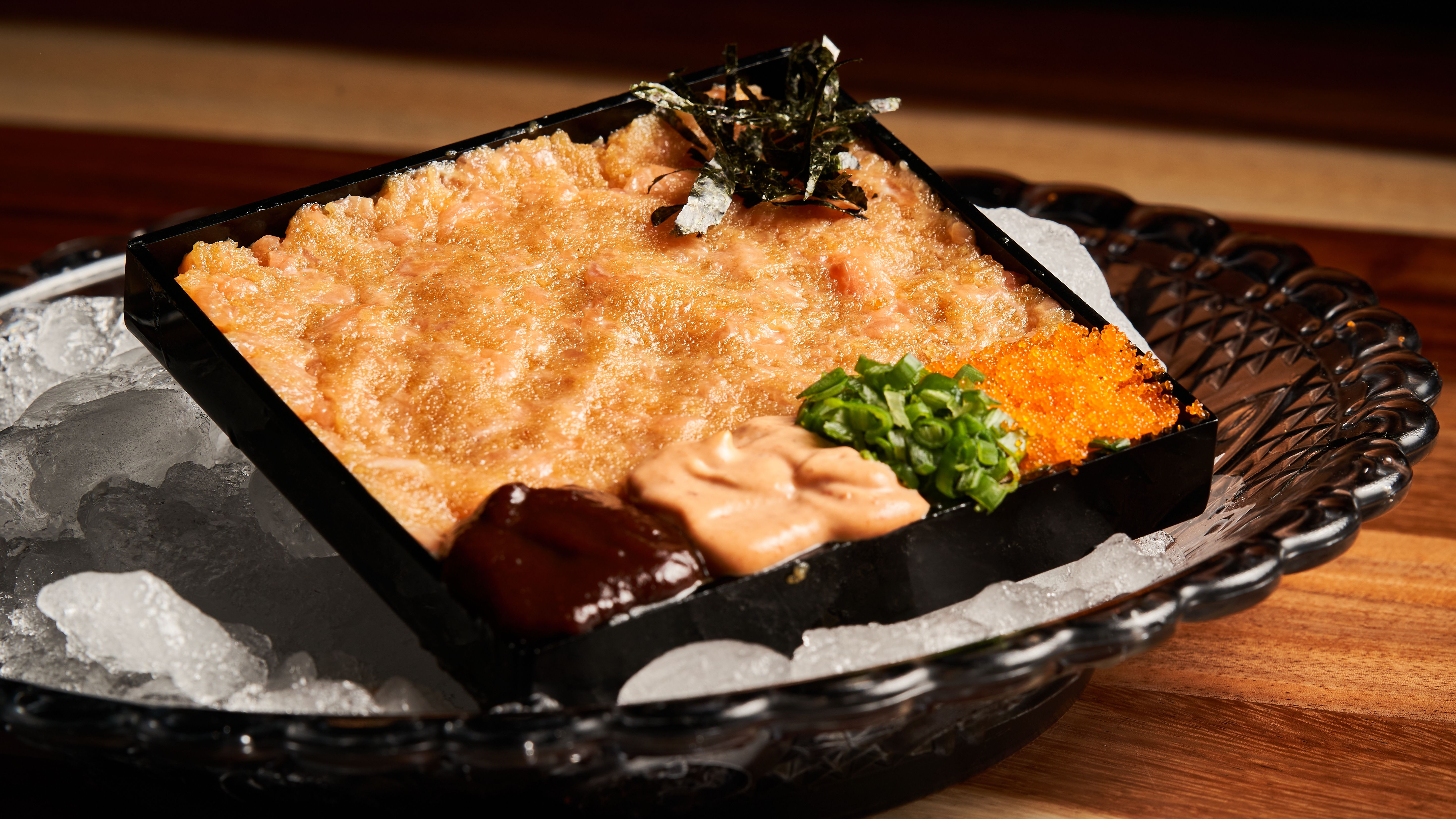 Close-up of sushi topped with vibrant masago fish roe