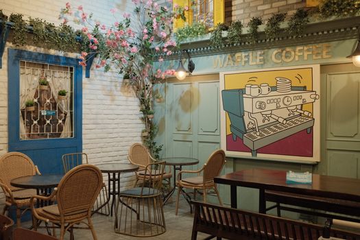 Cozy café interior featuring vintage decor, seating, and unique waffle coffee artwork.