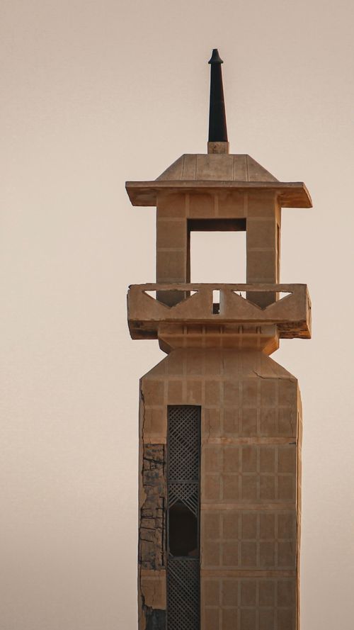 Free Desert minaret towers against a serene sunset sky, showcasing architectural beauty. Stock Photo