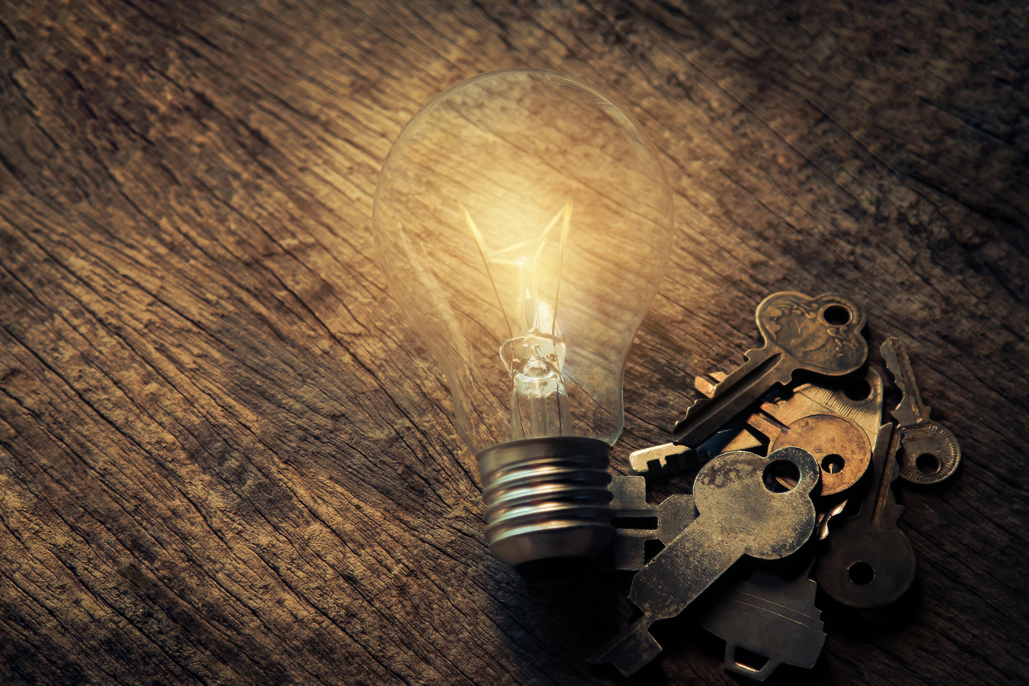 light bulb and keys on table