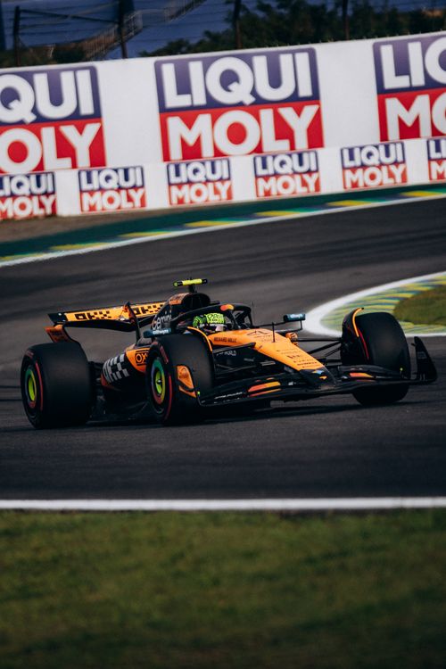 Free Dynamic Formula 1 race car speeding at São Paulo's iconic Interlagos circuit, showcasing thrilling motorsport action. Stock Photo