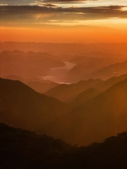 A breathtaking view of mountains under a vibrant sunset sky, offering serene and dramatic landscape.