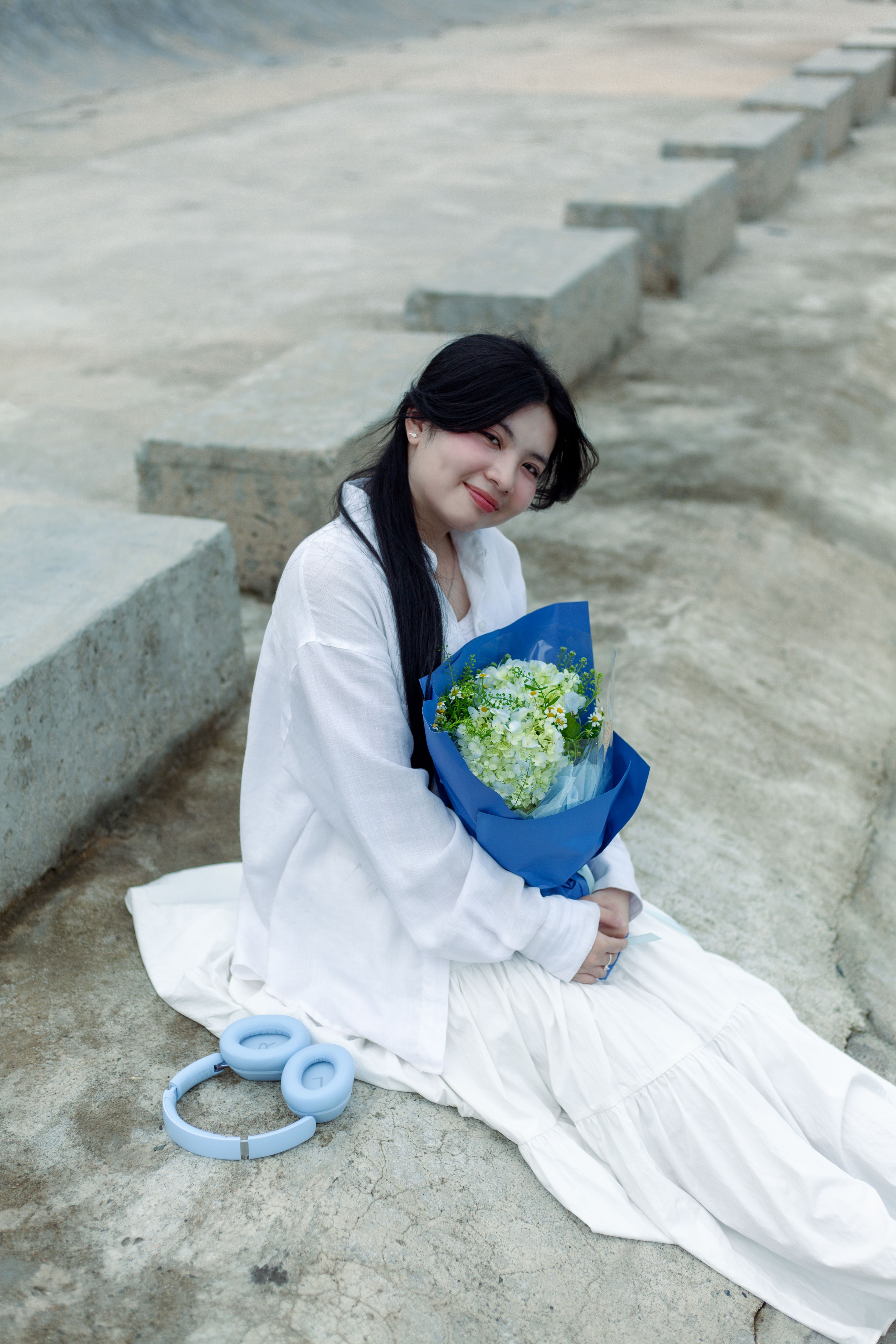 Young Woman Outdoors with Bouquet of Flowers · Free Stock Photo