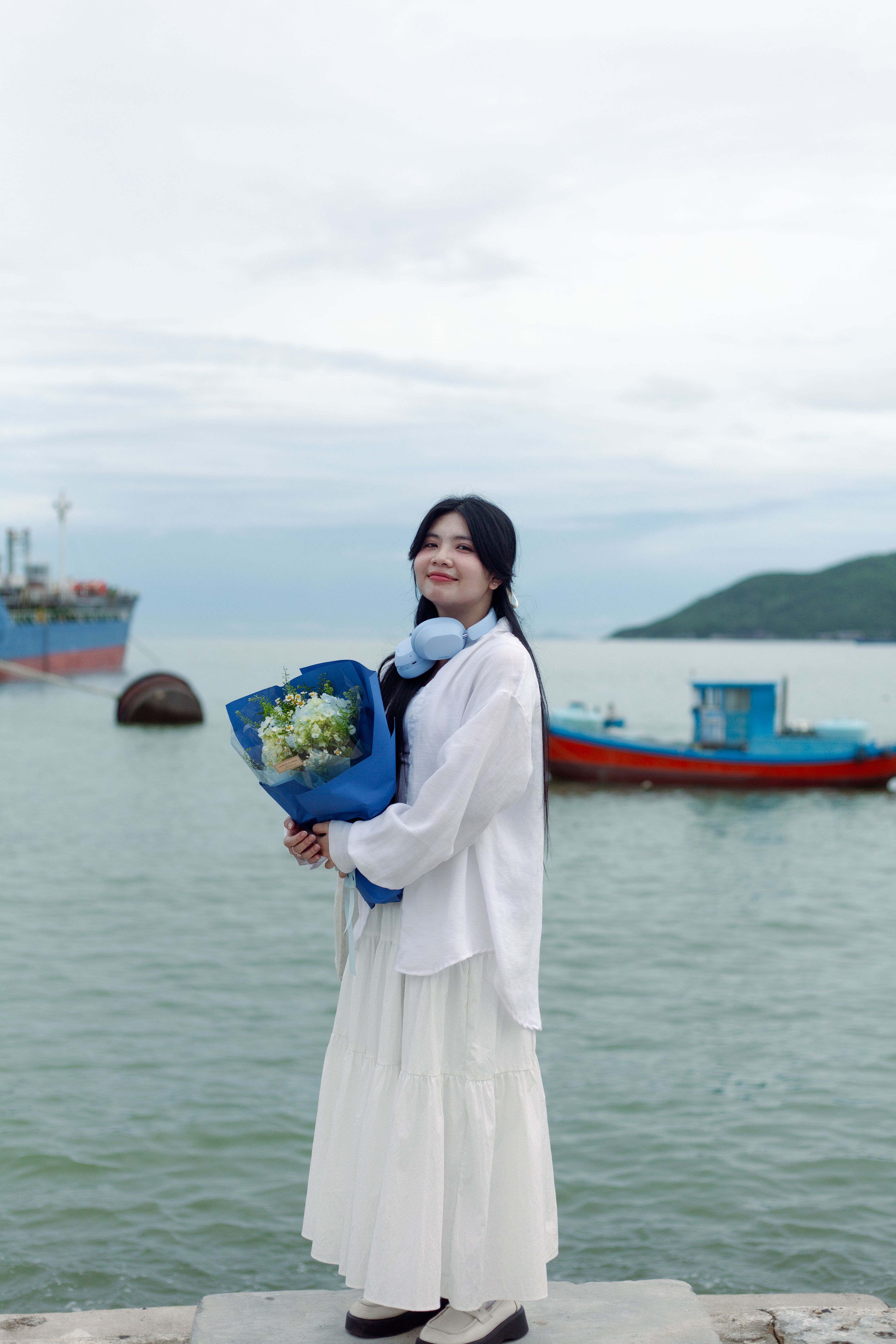 Young Woman with Bouquet by the Sea · Free Stock Photo