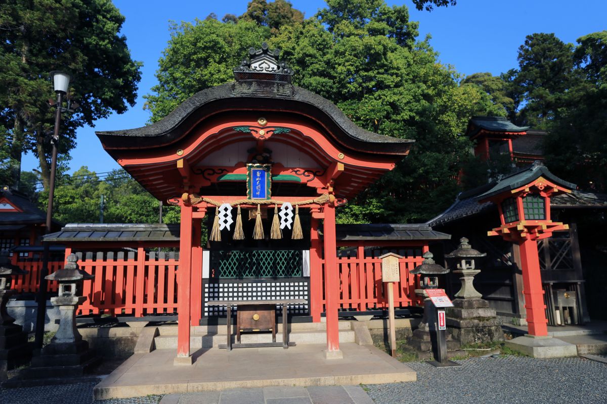 Traditional Japanese shrine courtyard with stone lanterns and wooden architecture in Fukuoka