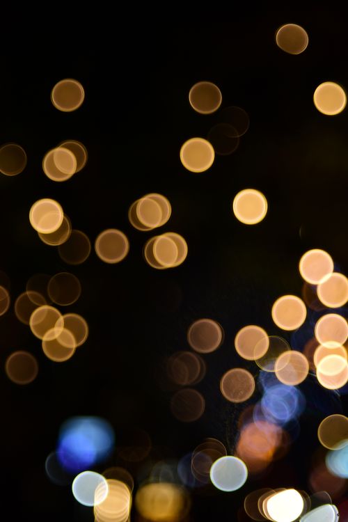 Free A captivating display of abstract bokeh light spots against a dark background, creating a mesmerizing visual effect. Stock Photo