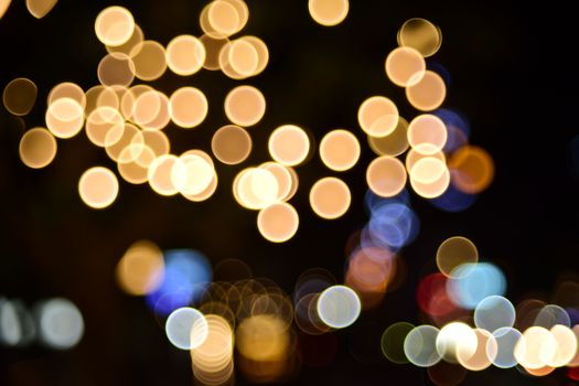 A stunning capture of night bokeh lights in warm and cool tones, creating an abstract circular pattern.