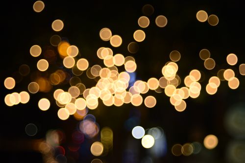 Free Golden bokeh lights creating an abstract pattern against a dark night background, perfect for festive and dreamy designs. Stock Photo