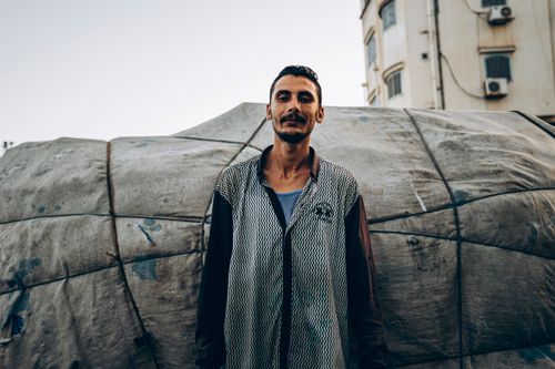 Free Candid portrait of a fisherman against a boat backdrop in Damietta, Egypt. Stock Photo