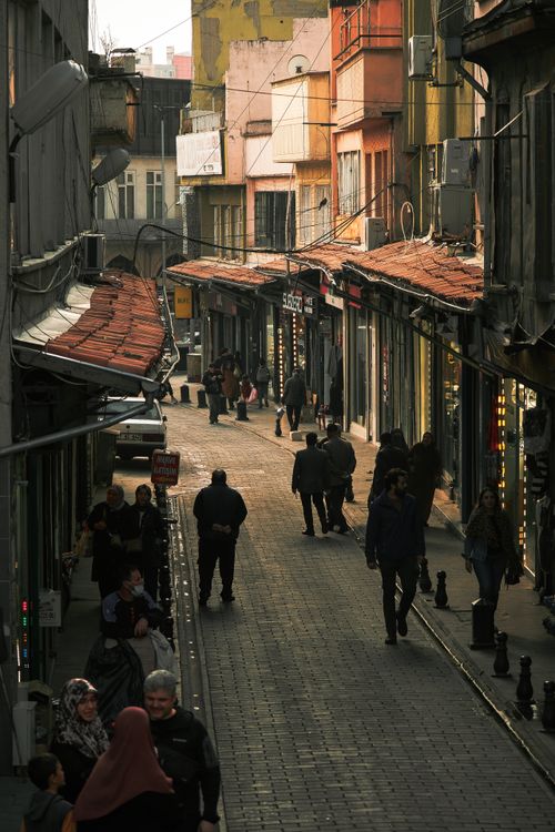 Free Crowd walking down a lively alleyway lined with shops in urban setting. Stock Photo