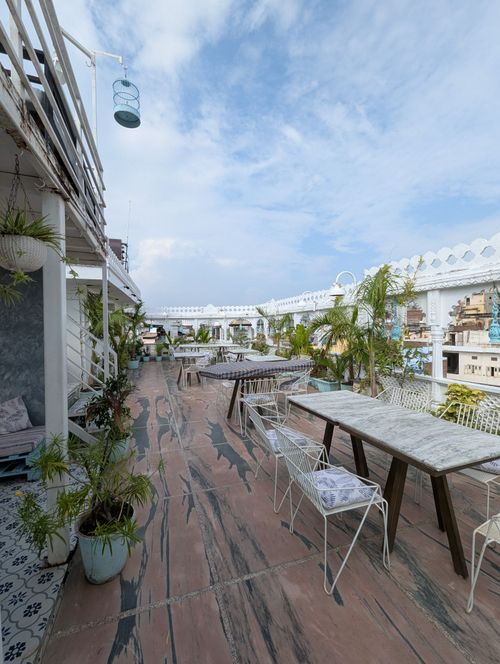Free A peaceful rooftop cafe in Udaipur, India, offering scenic views and modern decor. Stock Photo