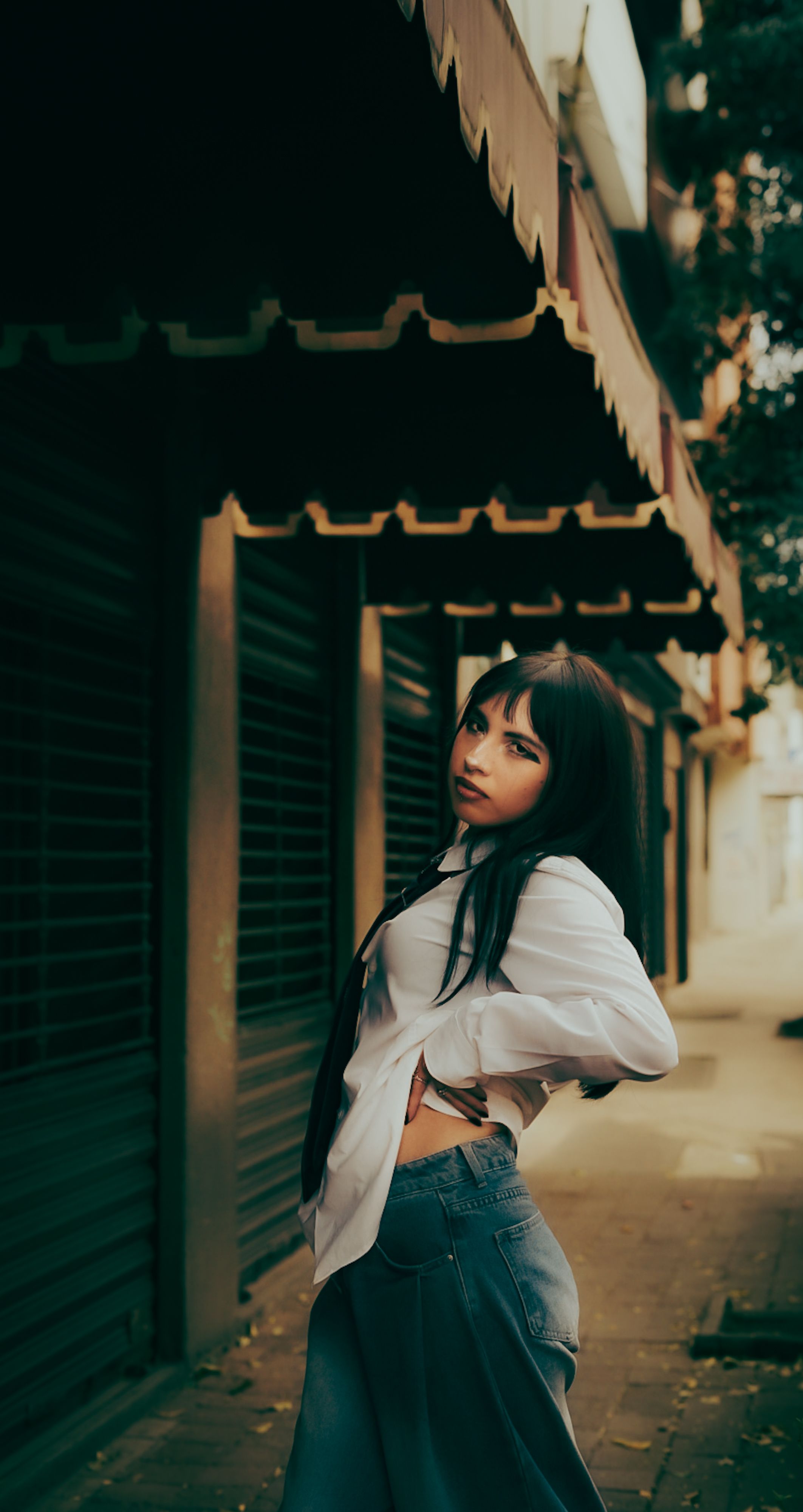 Stylish Woman Posing in Urban Street Setting · Free Stock Photo