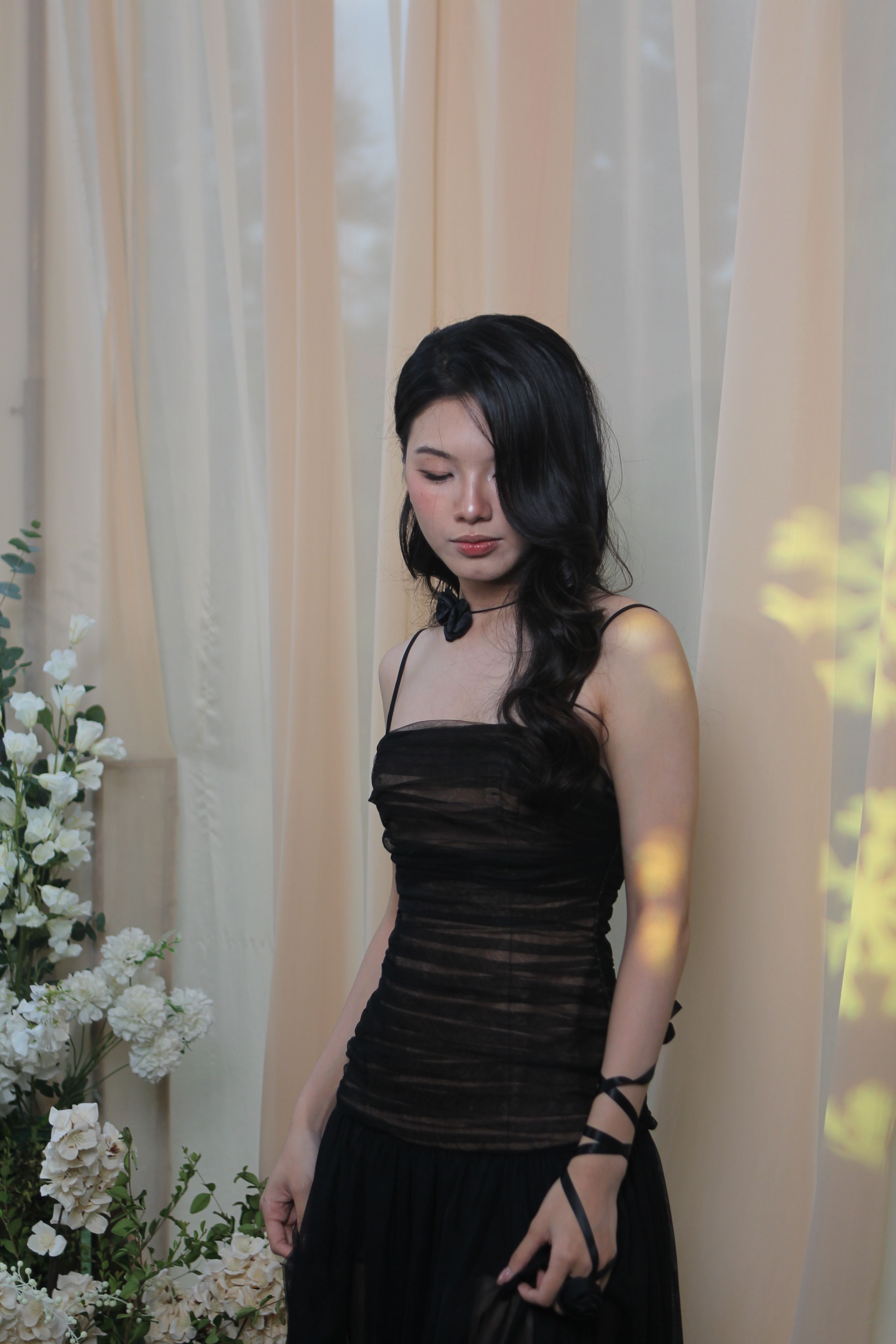 Elegant Woman in Black Dress with Floral Background · Free Stock Photo