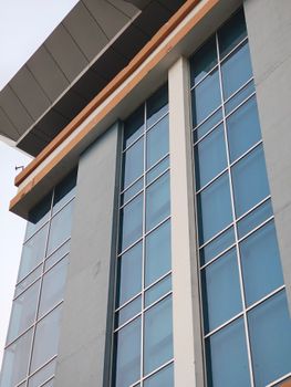 Contemporary architectural design featuring reflective blue glass windows.