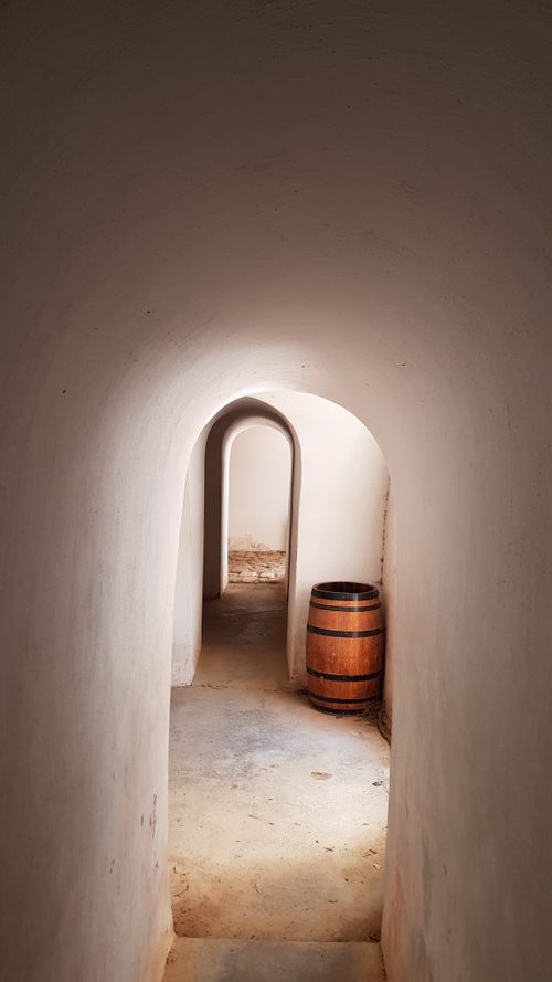 Free A vintage wine cellar corridor with wooden barrel in Cape Town, South Africa. Stock Photo