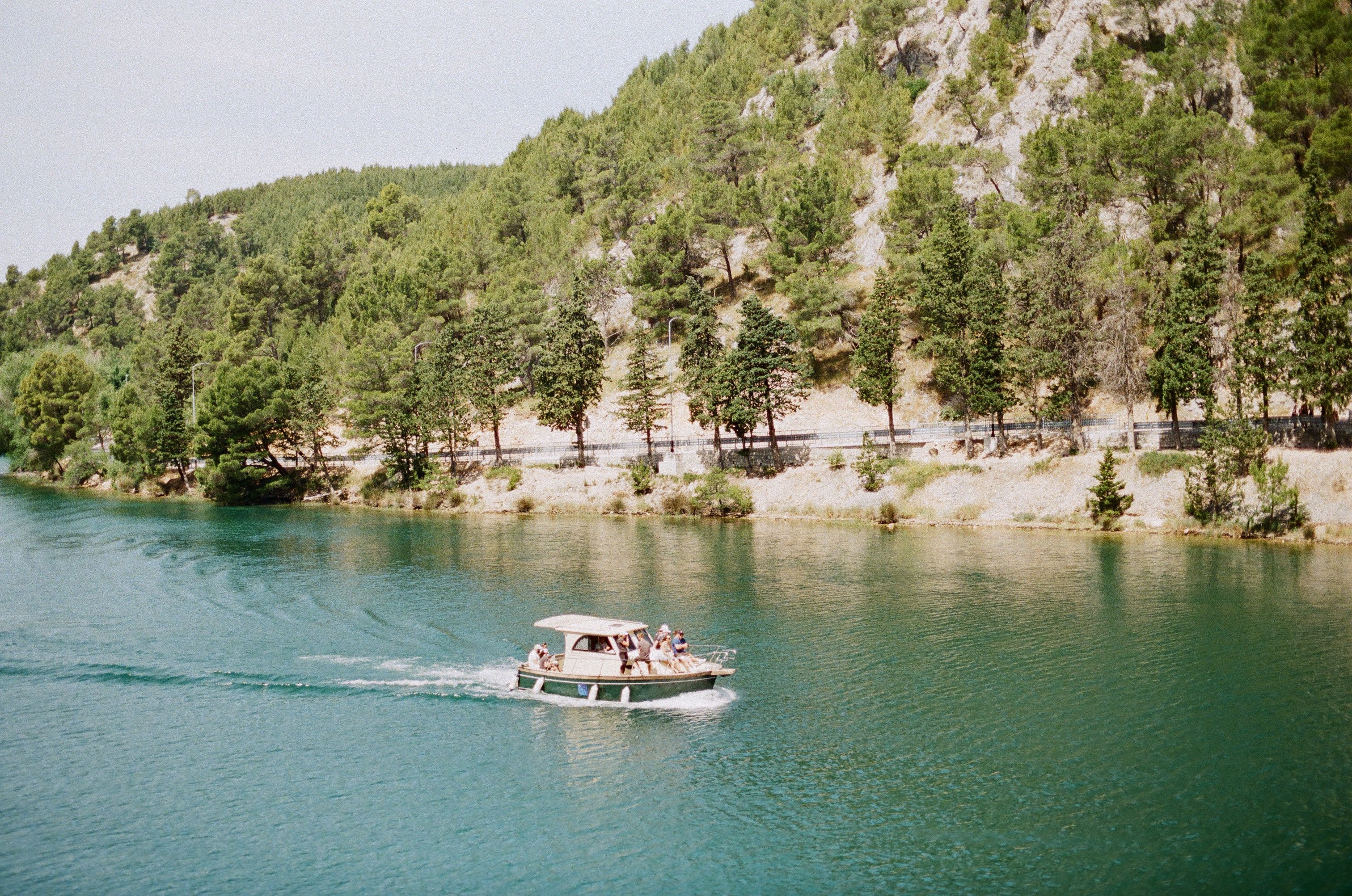 Scenic Boat Ride Along a Forested River · Free Stock Photo