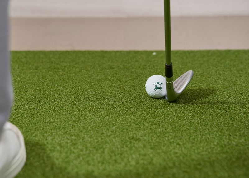 A player lining up a shot on indoor turf