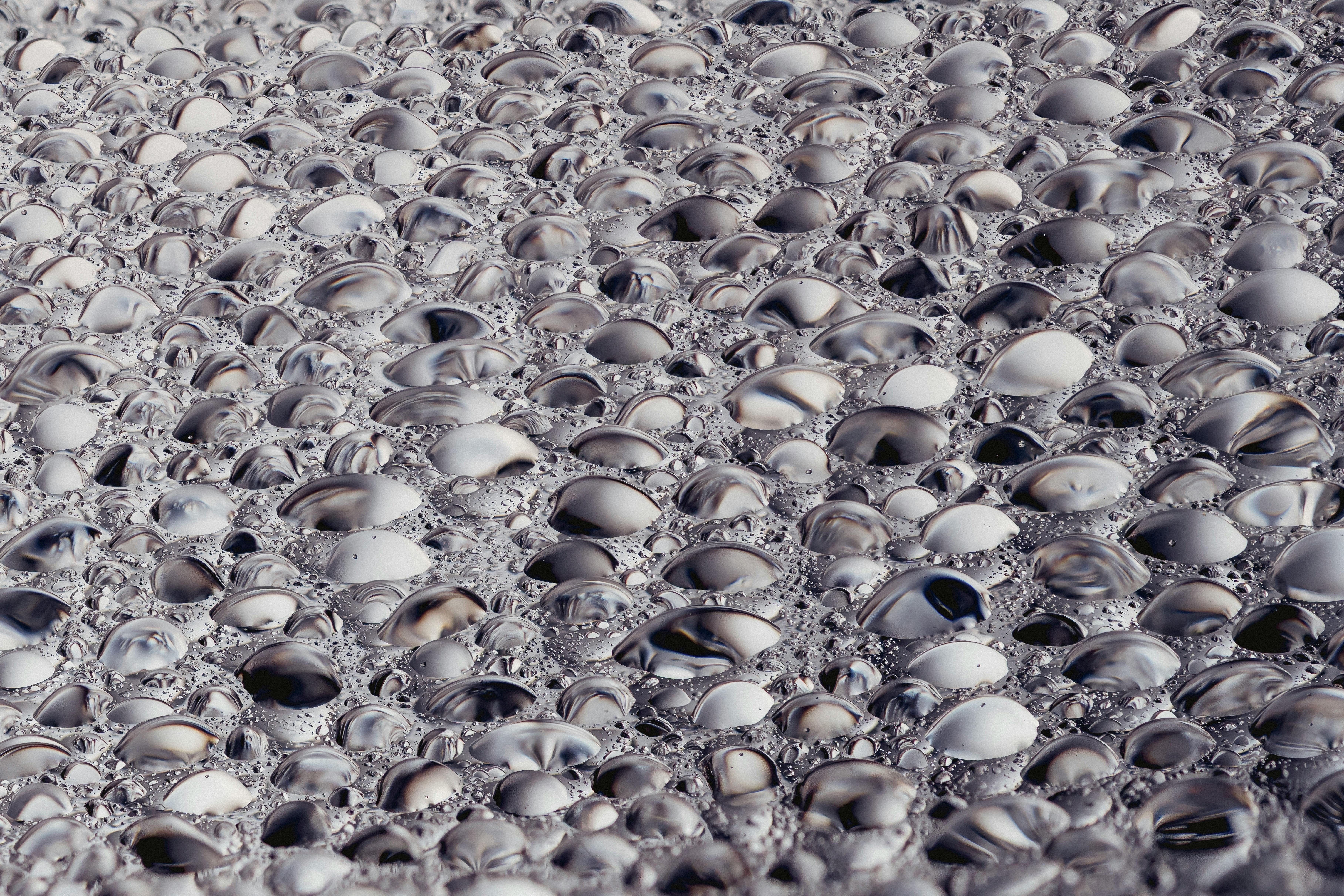 A detailed texture of reflective soap bubbles patterning a surface.