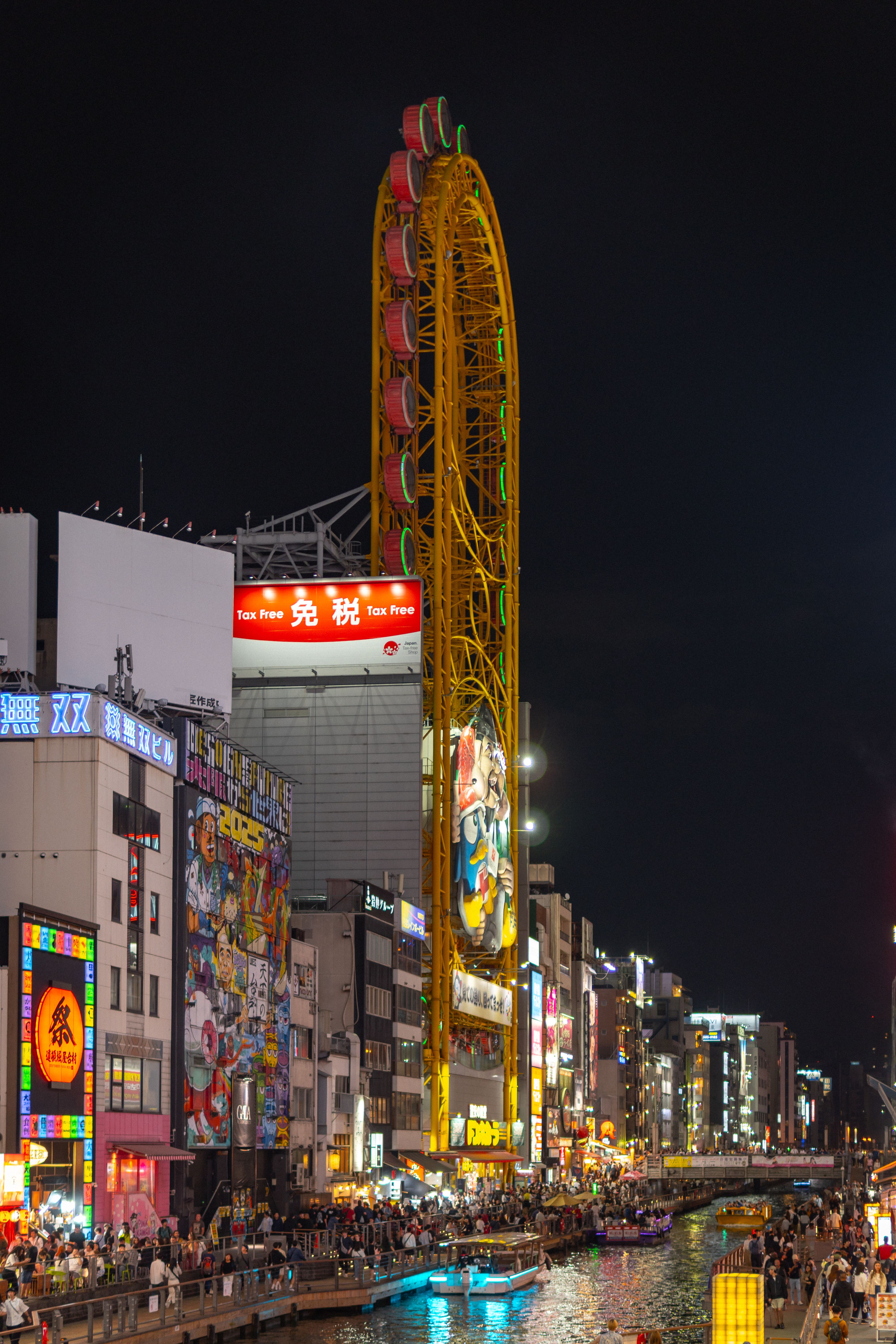 Dotonbori street at night with bright lights and crowds