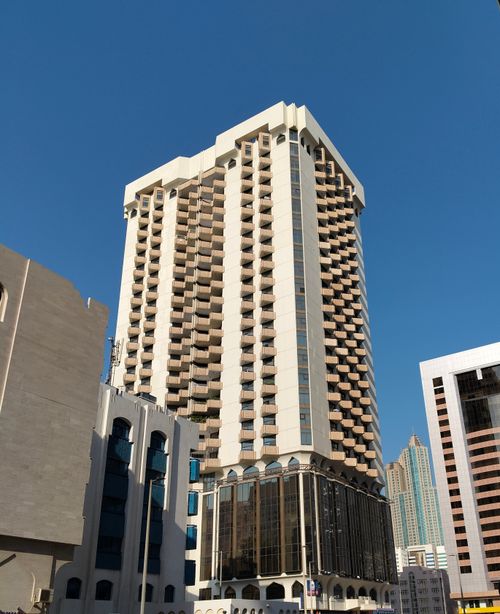 Free High-rise buildings in a city downtown with clear blue sky, showcasing modern architecture. Stock Photo