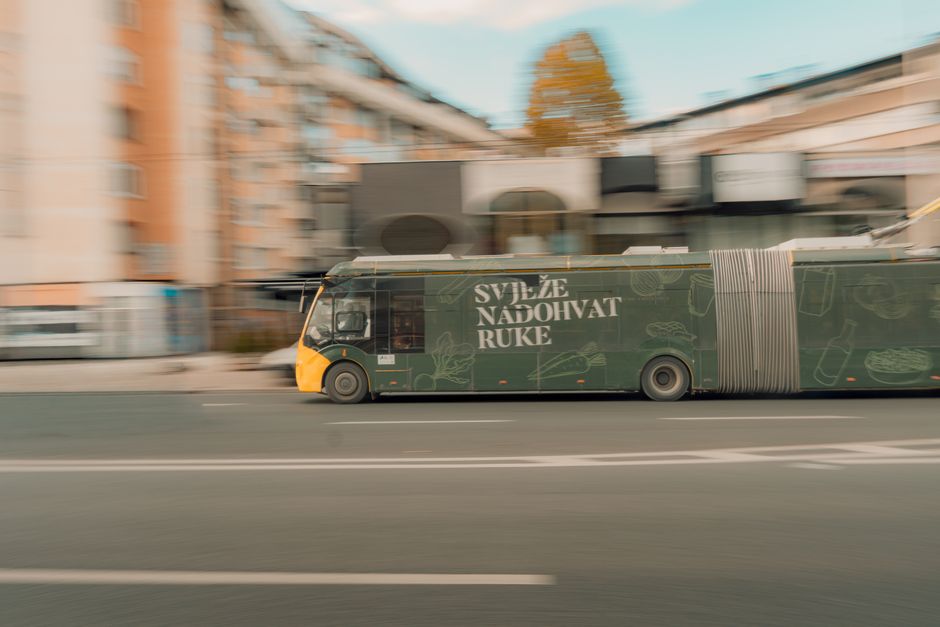 A modern Tallinja public bus driving on a street in Malta