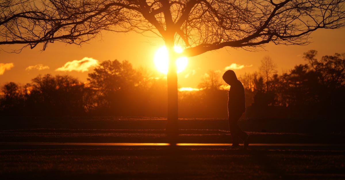 person walking outdoors after meal sunlight