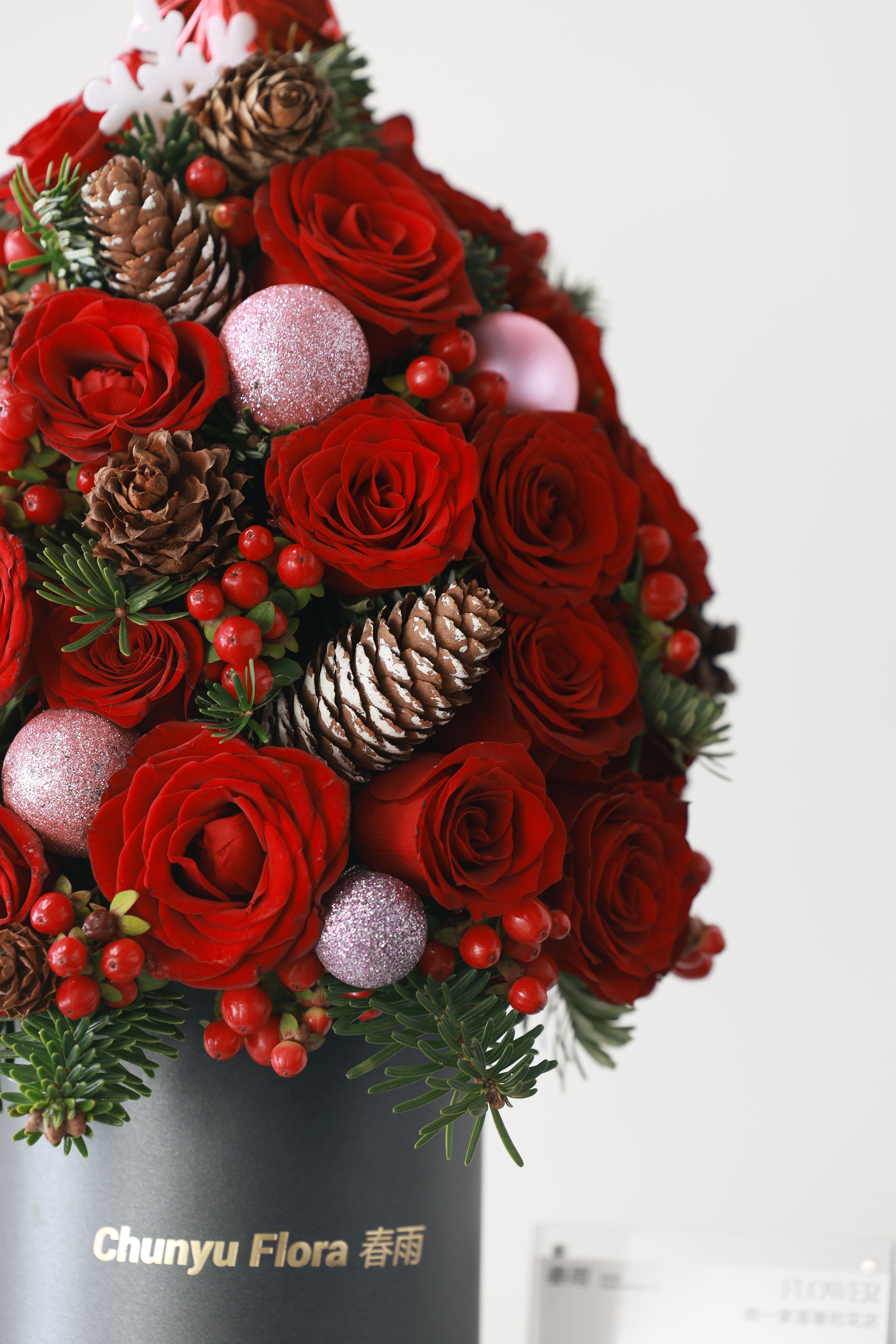 Festive Floral Arrangement with Red Roses and Pine Cones · Free Stock Photo