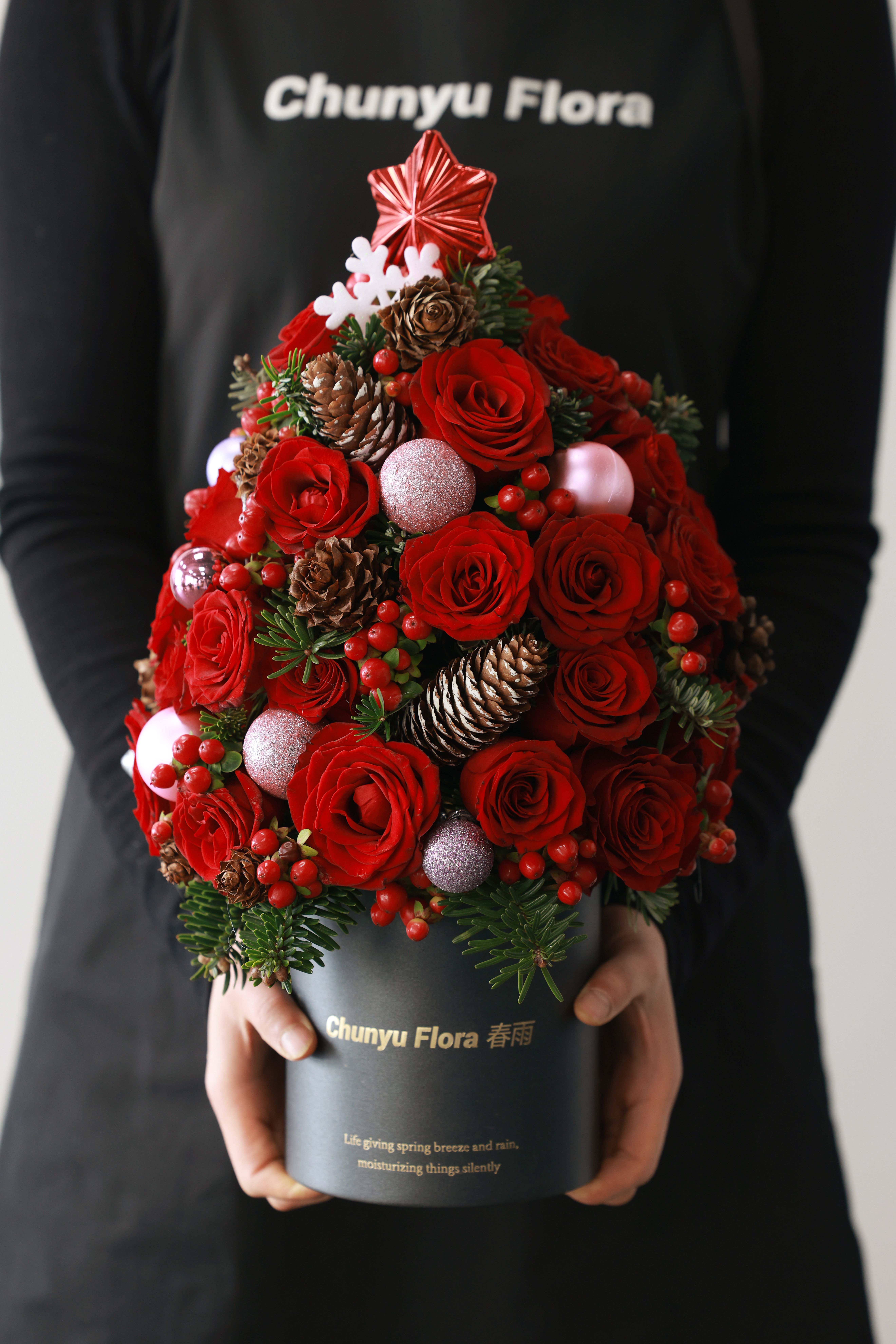 Festive Floral Arrangement with Red Roses and Pine Cones · Free Stock Photo