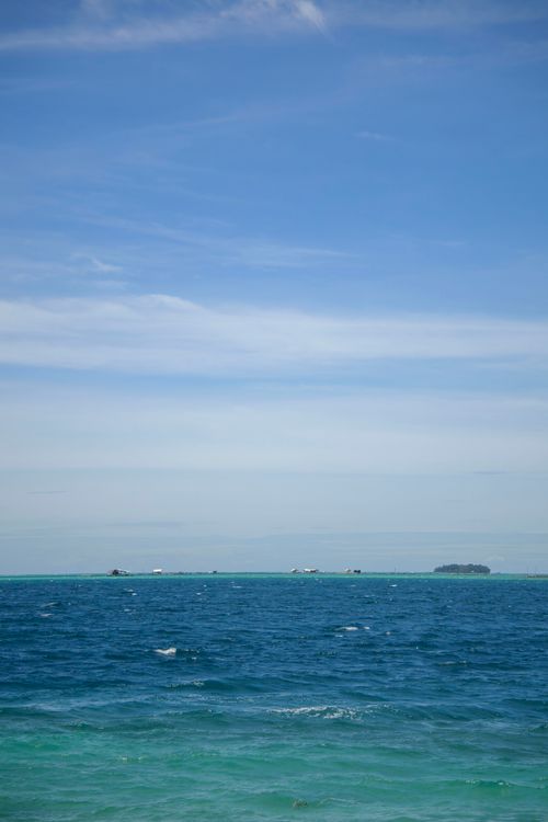 Free Serene ocean view with distant islands under a clear blue sky in Jakarta, Indonesia. Stock Photo