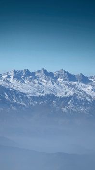 Breathtaking view of a snow-covered mountain range under a clear blue sky.