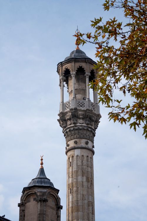 Free Tall minaret with intricate design against sky, surrounded by autumn trees. Stock Photo