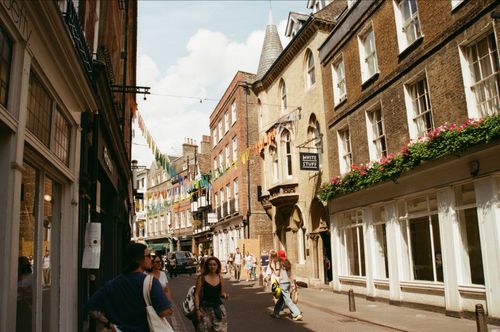 Free Vibrant street scene with people and historic buildings in Cambridge, England. Stock Photo