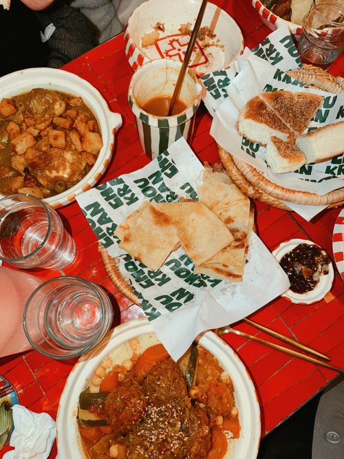 Free Middle Eastern meal with pita bread and assorted dishes on a vibrant table. Stock Photo