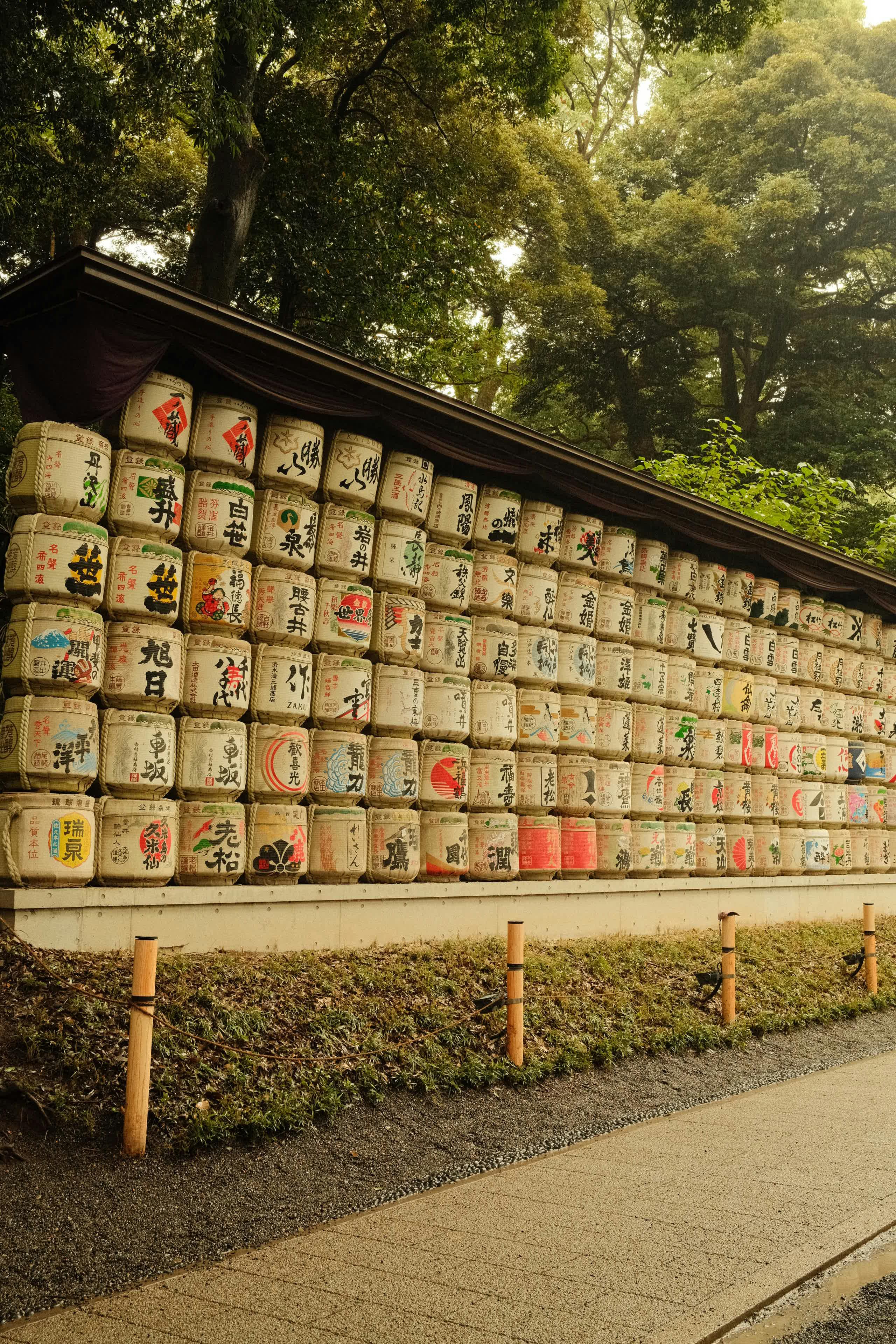 Traditional sake barrels on display at Meiji Shrine in Tokyo, showcasing cultural heritage.
