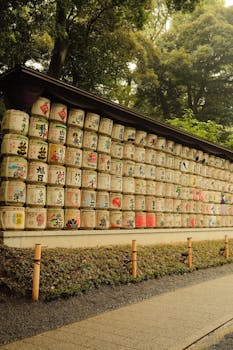 Traditional sake barrels on display at Meiji Shrine in Tokyo, showcasing cultural heritage.