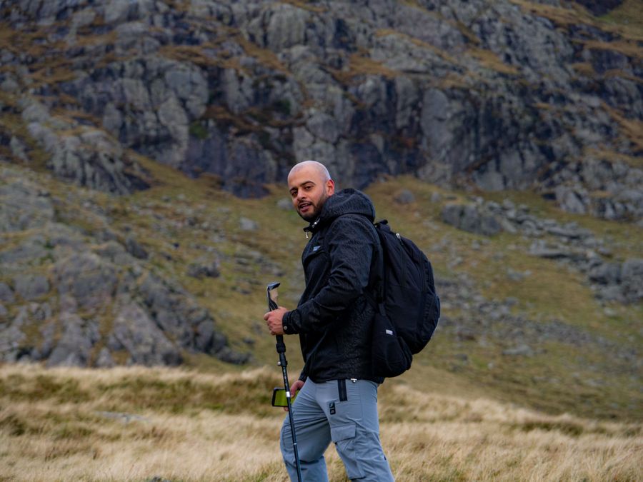 Illustrator walking a mountain trail with a backpack — Vintage Laka on Pexels