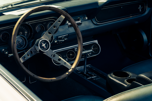 Close-up of a classic Ford Mustang interior showcasing the vintage steering wheel in Zapopan, Mexico.