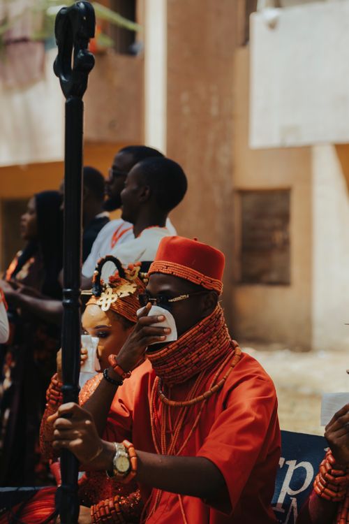 Free People in vibrant attire at a traditional Nigerian wedding ceremony, outdoors, daytime. Stock Photo