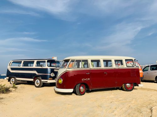 Free Vintage Volkswagen camper vans parked by Malta's scenic coast under a bright sky. Stock Photo