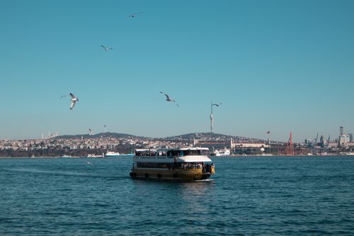 Free A ferry cruises along the Bosphorus with Istanbul's iconic skyline in the background. Stock Photo