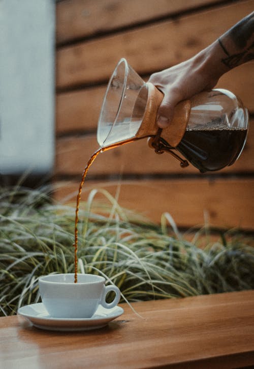 Person Pouring Coffee on a Mug