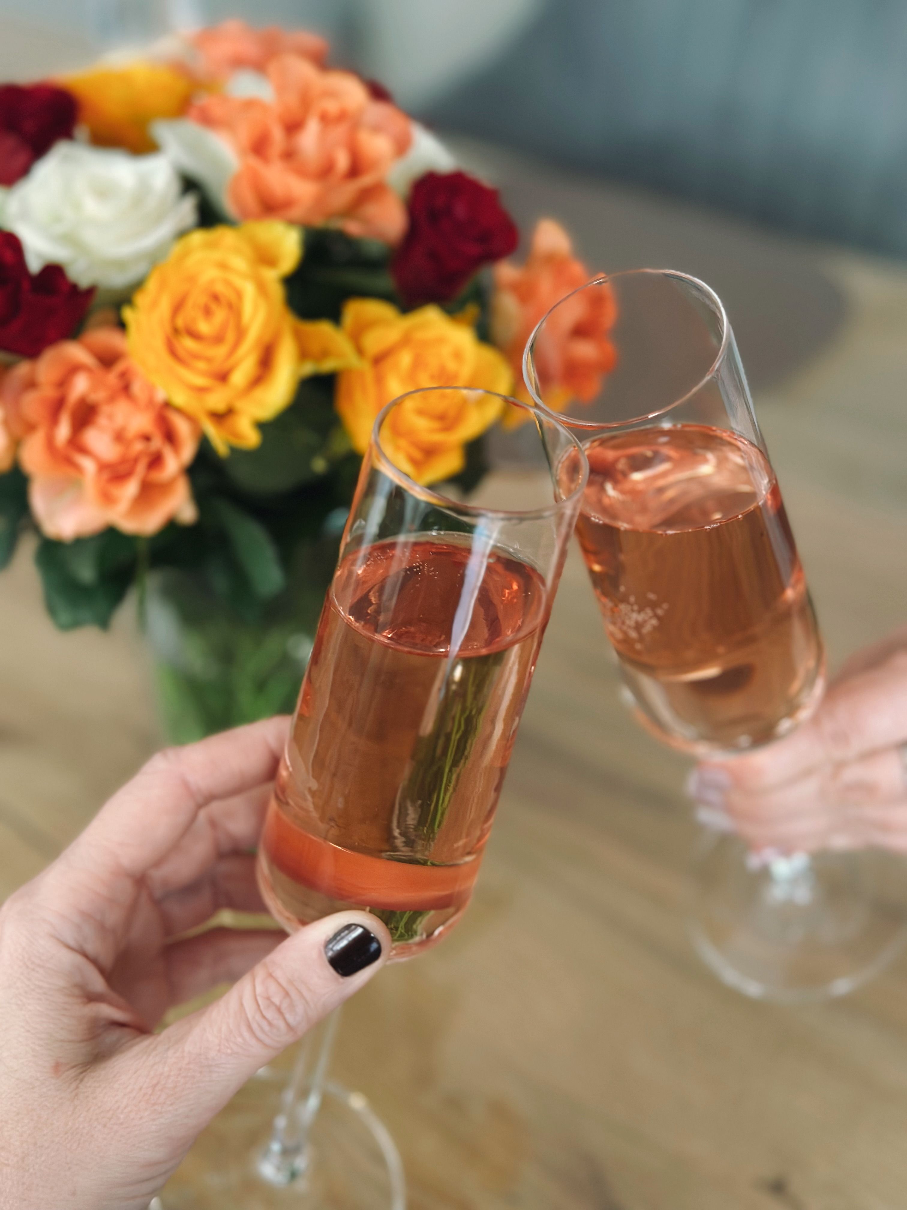 Elegant Champagne Toast with Colorful Roses · Free Stock Photo
