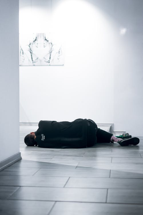 Free Man Lying on Floor Stock Photo