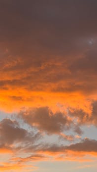 A stunning view of orange and purple clouds during sunset, creating a dramatic sky.