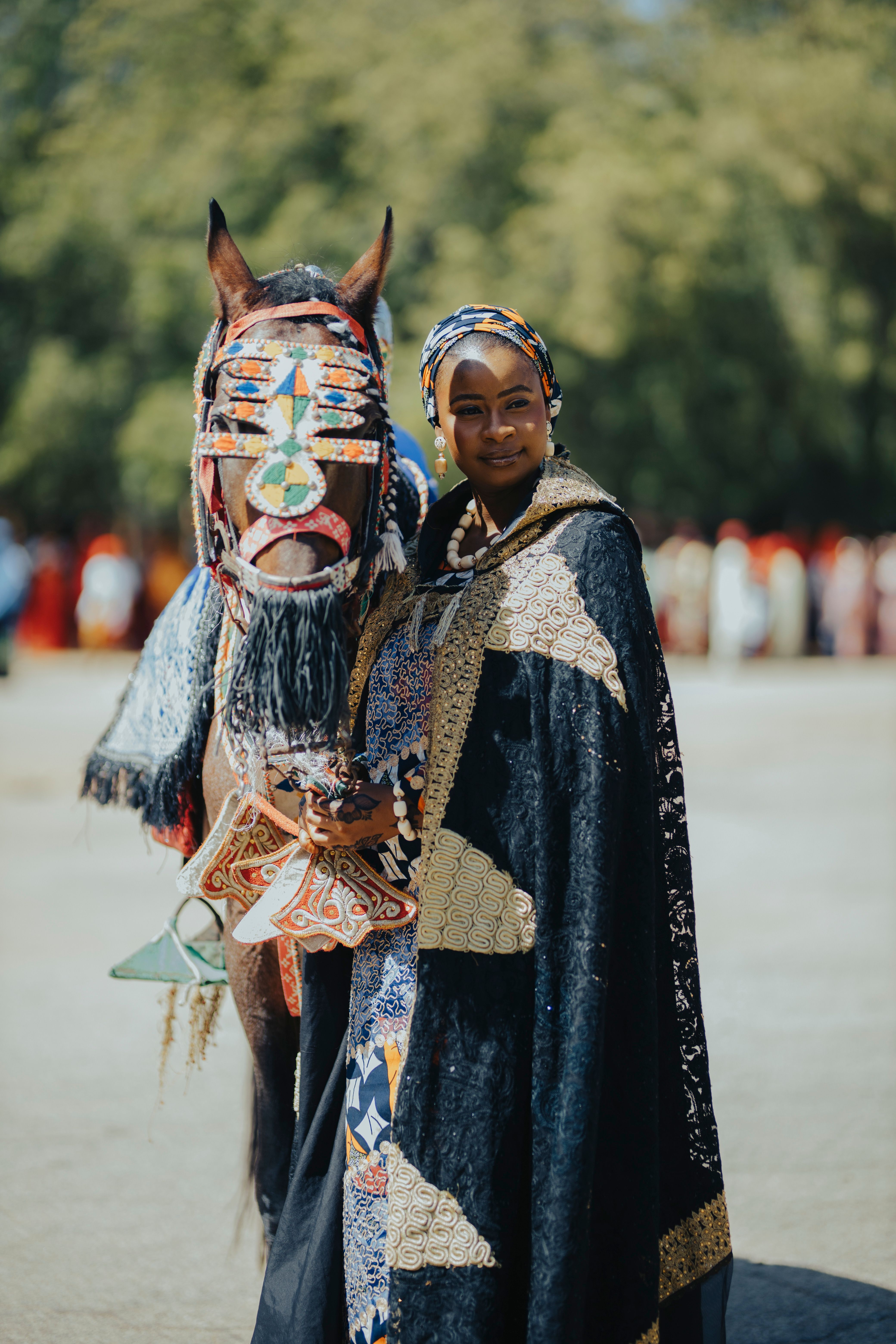 African Woman Posing with Decorated Horse in Traditional Attire · Free ...