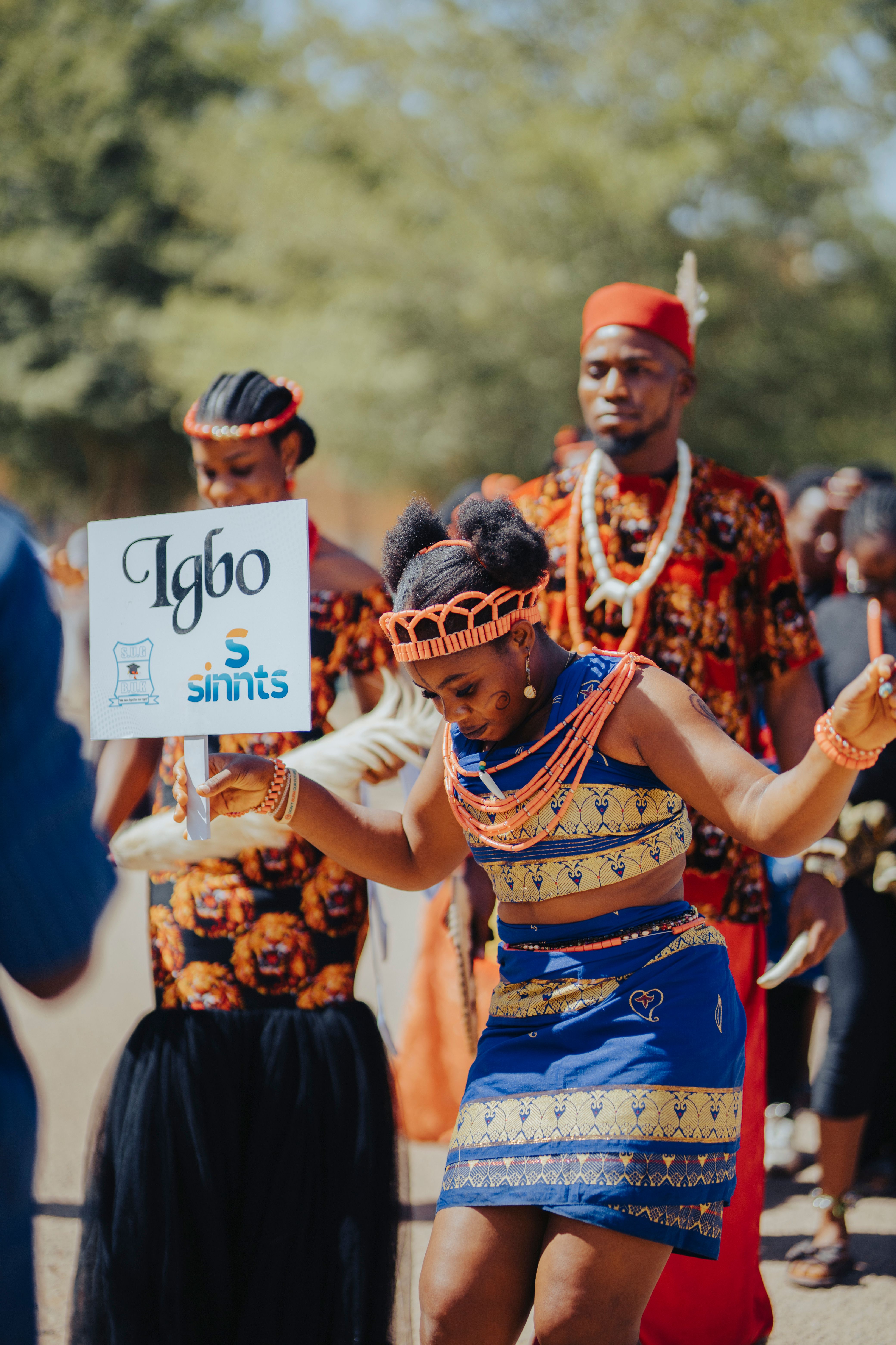Colorful Igbo cultural parade showcasing traditional attire and dance.