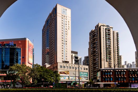Contemporary urban scene featuring high-rise buildings under a clear blue sky.