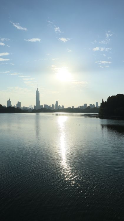 Sunrise over City Skyline with Reflective Water · Free Stock Photo