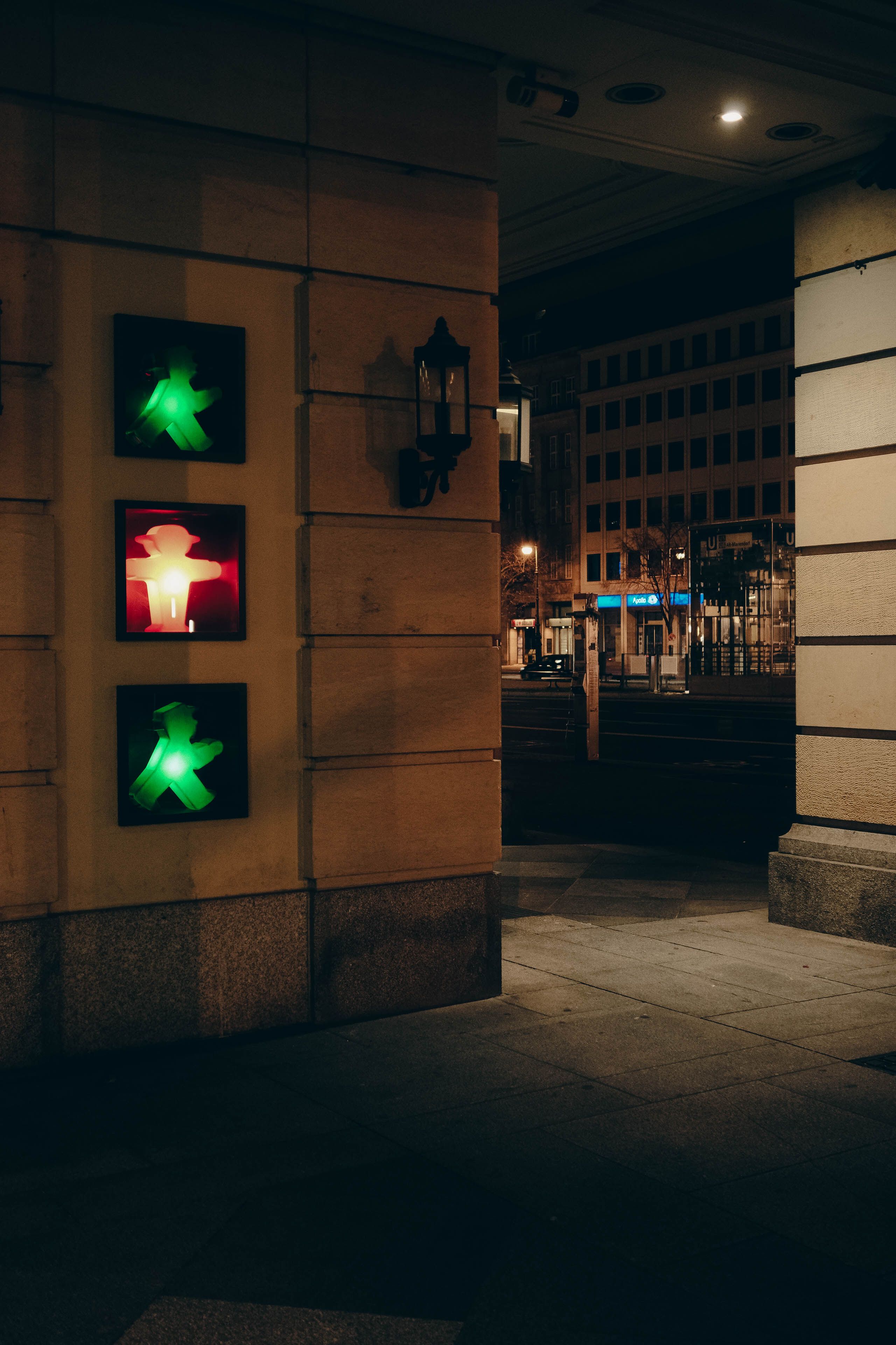 Urban scene in Berlin at night featuring illuminated pedestrian traffic lights.